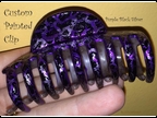 purple clip in hand-c